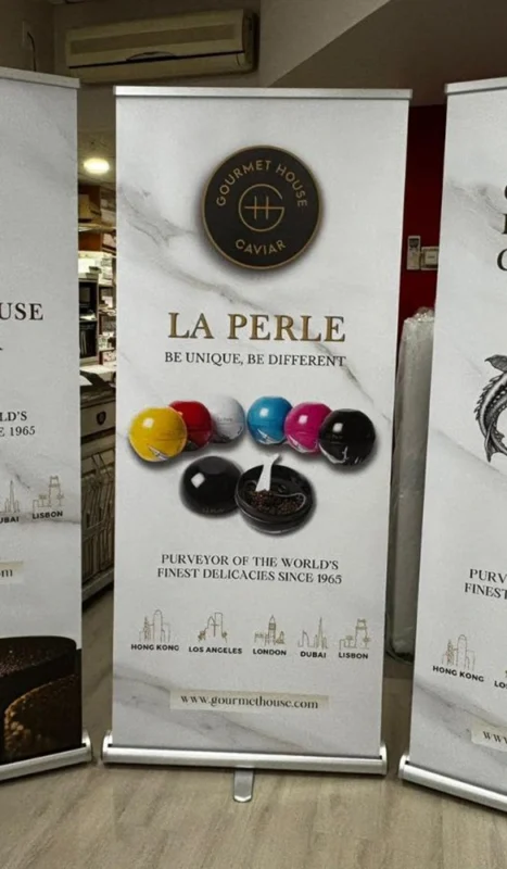 Luxury roll up banner for La Perle caviar by Gourmet House with colorful caviar visuals and global city icons